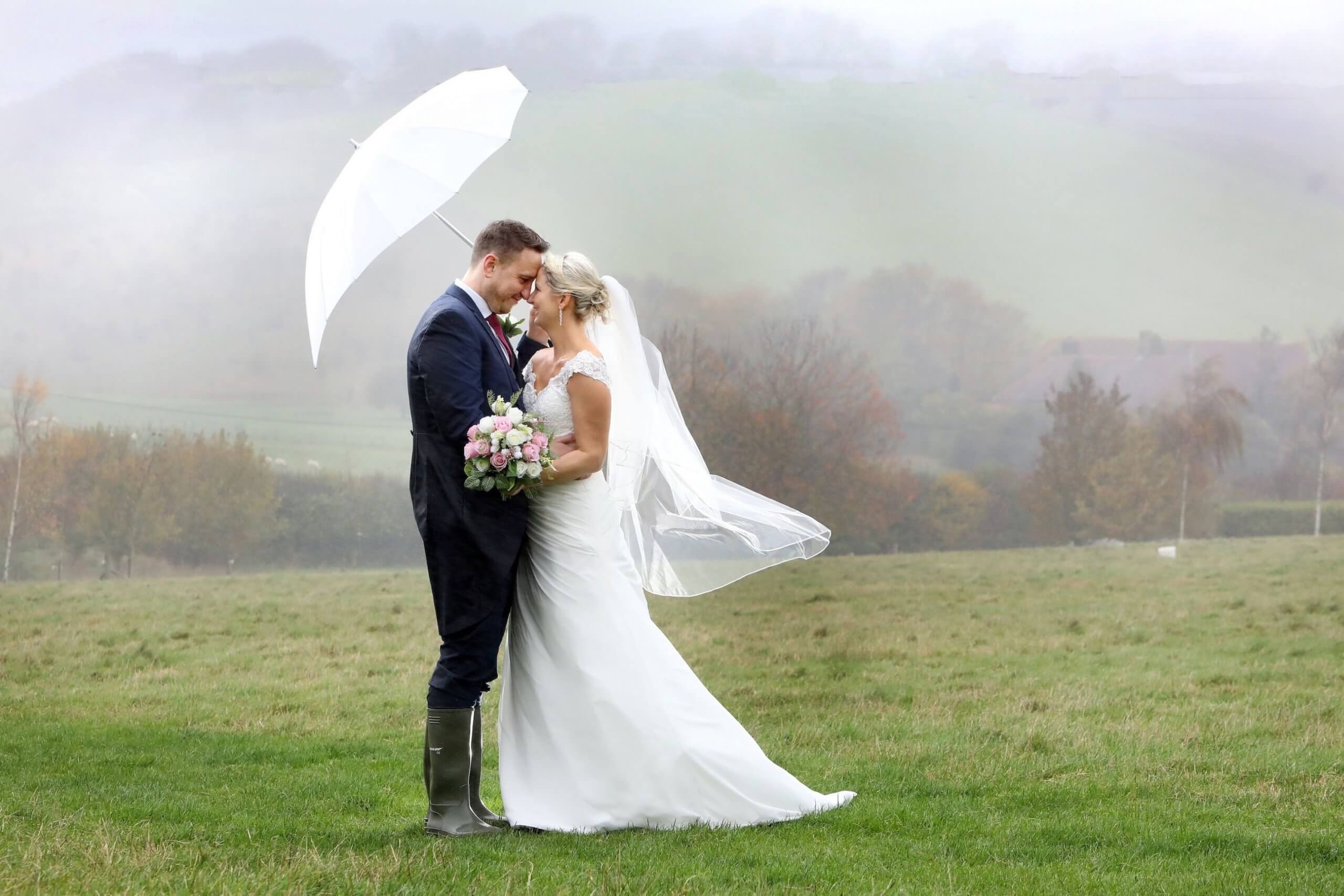 Wedding photographer Upwaltham Barns Winter umbrella